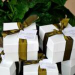 White gift boxes, luxe ribbon & custom tags. Bamboo coasters were placed inside as the favor.