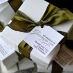 White gift boxes, luxe ribbon & custom tags. Bamboo coasters were placed inside as the favor.